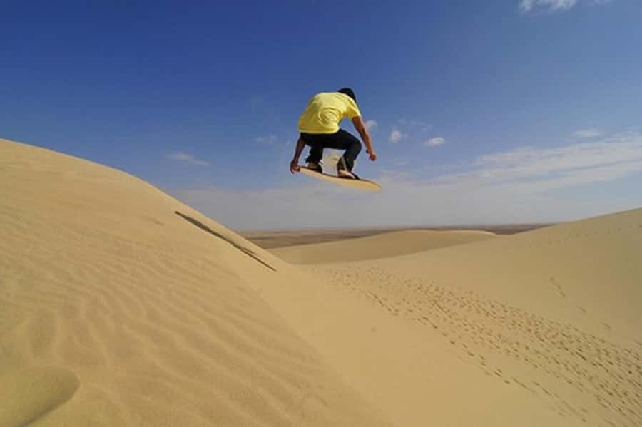 Desert Safari, Quad Bike, Camel Ride, Falcon & Sandboarding - Sandboarding From the Highest Dunes