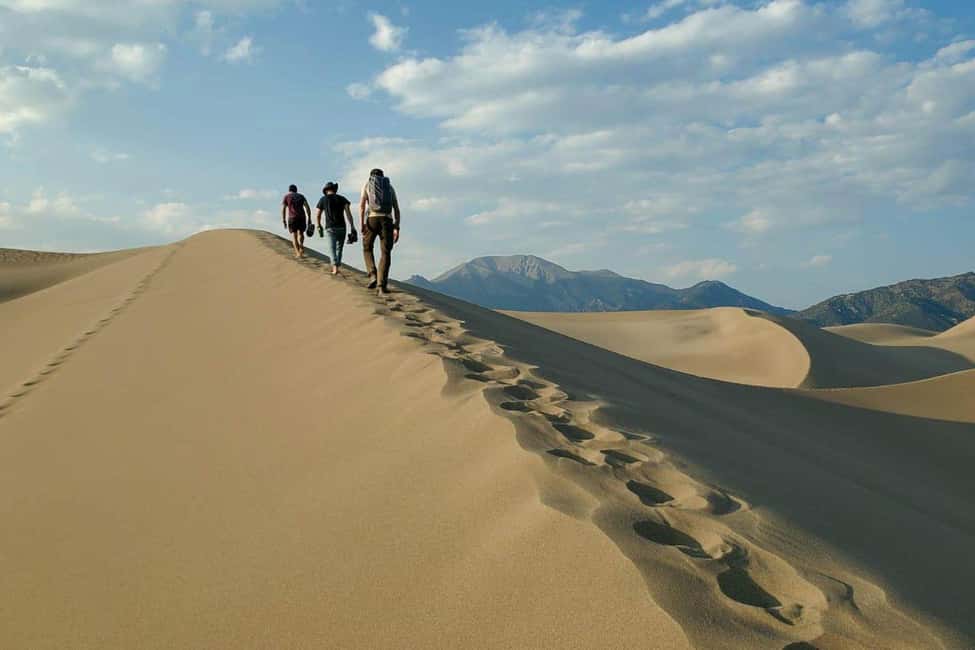 Desert Safari, QuadBike,Dune buggy, Sandboarding & CamelRide - Sandboarding down the dunes