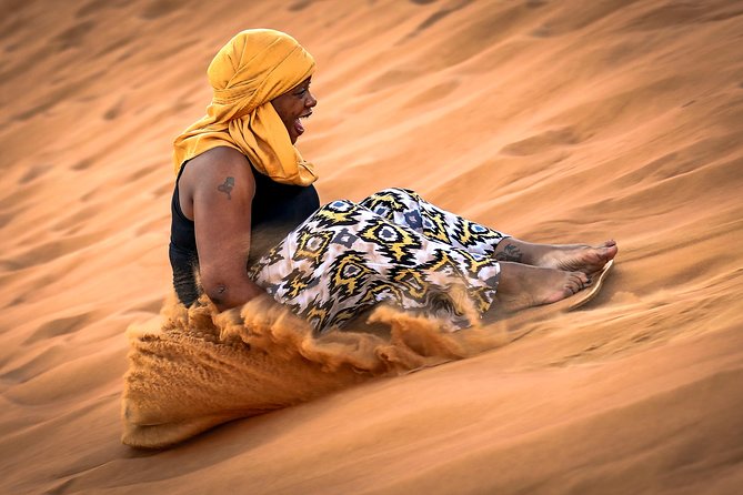 Doha Desert Safari: Dunebashing, Camel, Sandboarding & Inland Sea - Sandboarding across the dunes