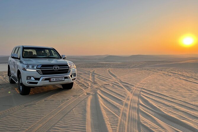 Doha: Desert Safari, Sand Boarding, Camel Ride & Inland Sea Tour - Dune bashing across Qatar’s open sand