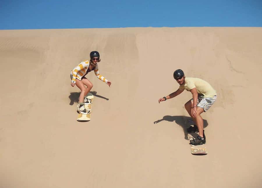 Doha Desert Safari: Sandboarding, Camel Ride & Swimming Fun - What the guides add to the day