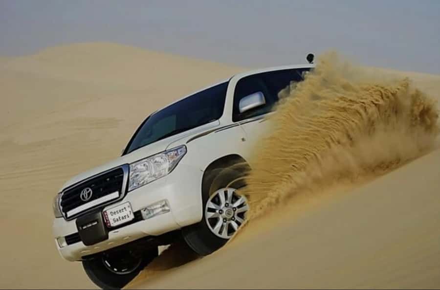 Doha: Half Day Desert Safari With Camel Ride & Sand Boarding - Leaving Doha in a cooled 4WD