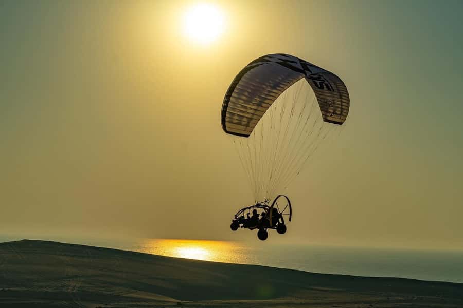 Doha: Paratrike Air Tour with Hotel Pickup and Drop-off - Preparing for takeoff beside Sealine beach