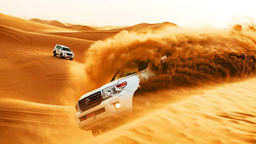 Doha: Safari, Camel Ride, Sandboarding and Inland Sea Tour - Dune bashing across Qatar’s golden sand