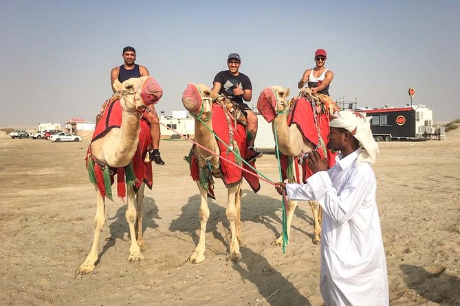 Doha: Sunset Desert Safari, Camels, Sandboarding & Inland Sea - Sandboarding across the dunes