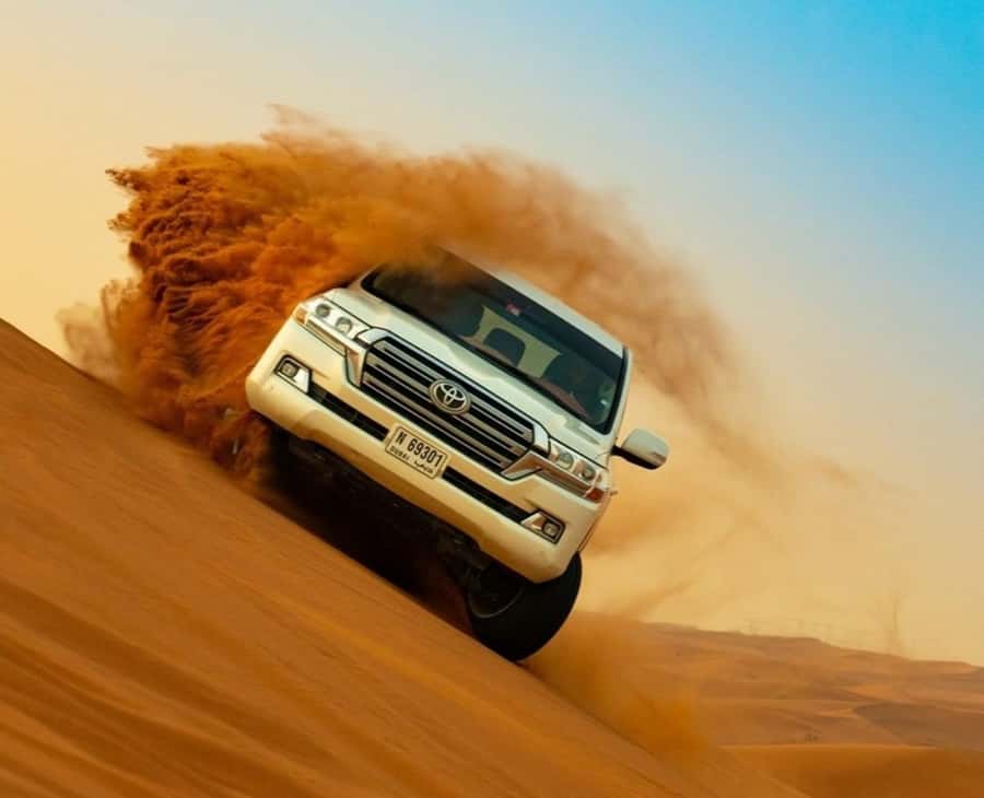 Qatar: Sunset Desert Safari with Camel Ride & Sandboarding - Sandboarding down the dunes